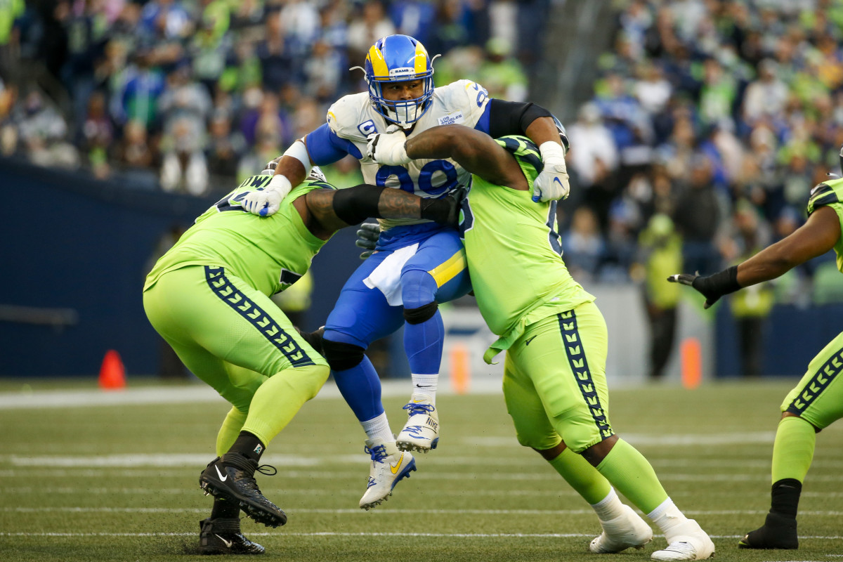 Oct 7, 2021; Seattle, Washington, USA; Los Angeles Rams defensive end Aaron Donald (99) is blocked by Seattle Seahawks offensive tackle Duane Brown (76, left) and guard Damien Lewis (68, right) during the second quarter at Lumen Field. Mandatory Credit: Joe Nicholson-USA TODAY Sports